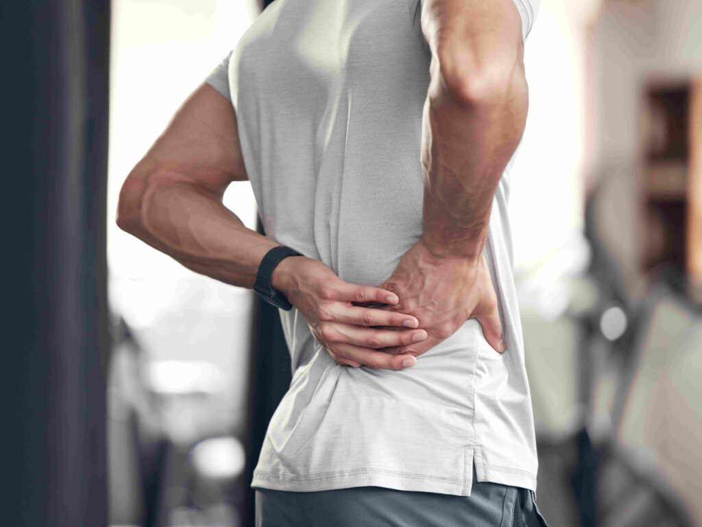 closeup of one mixed race man holding his sore low 2026 01 09 11 49 09 utc compressed 1 centrekineaddict.com